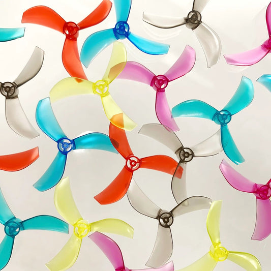 The BeeDrone Azi Micro Tri-Blade Prop set showing all available colors: Black, Red, Pink, Blue, Teal, Yellow, and Clear.